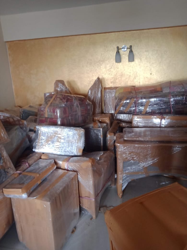 Professional movers packing kitchen items